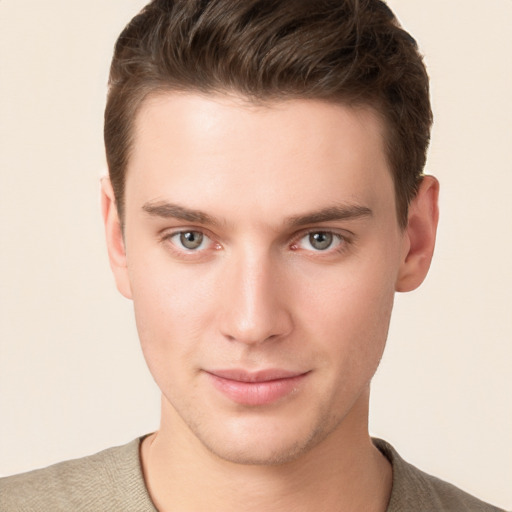 Joyful white young-adult male with short  brown hair and grey eyes