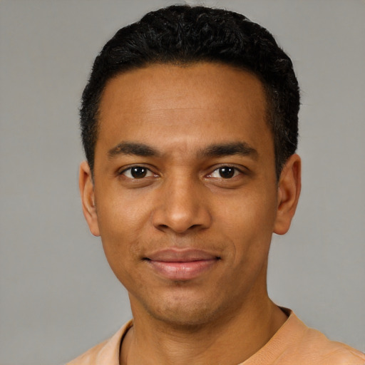 Joyful black young-adult male with short  black hair and brown eyes