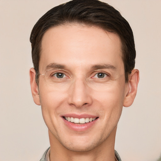 Joyful white young-adult male with short  brown hair and brown eyes