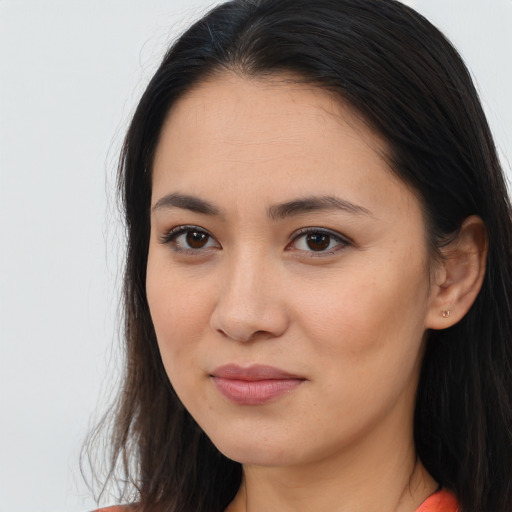 Joyful asian young-adult female with long  brown hair and brown eyes
