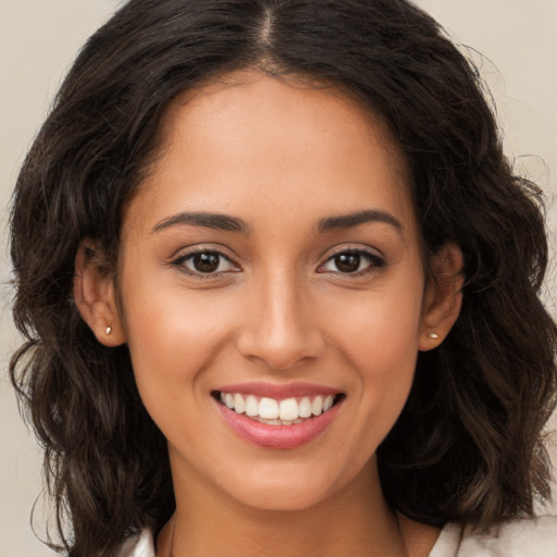 Joyful white young-adult female with long  brown hair and brown eyes