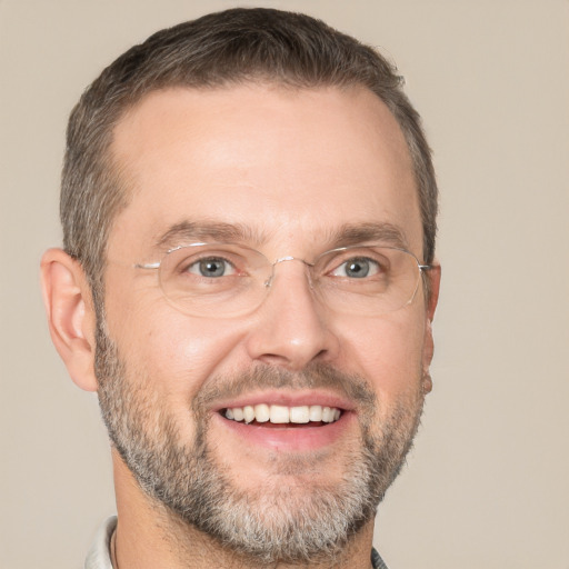 Joyful white adult male with short  brown hair and brown eyes