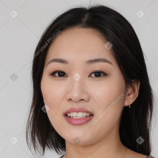 Joyful asian young-adult female with long  brown hair and brown eyes