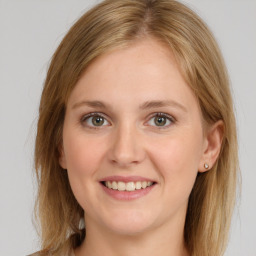 Joyful white young-adult female with long  brown hair and grey eyes