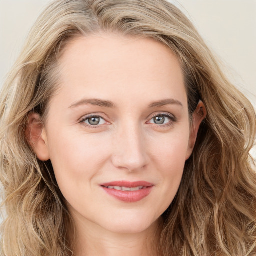 Joyful white young-adult female with long  brown hair and blue eyes