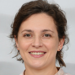 Joyful white adult female with medium  brown hair and brown eyes