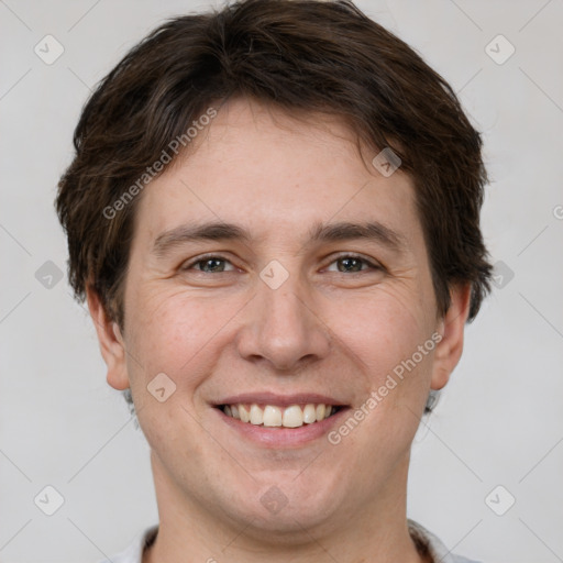 Joyful white adult male with short  brown hair and grey eyes