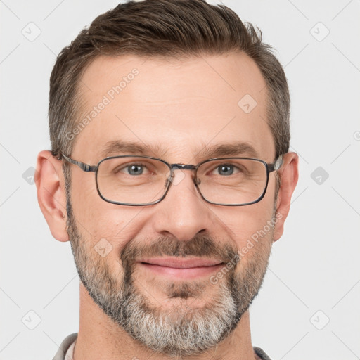 Joyful white adult male with short  brown hair and grey eyes