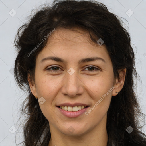 Joyful white adult female with long  brown hair and brown eyes