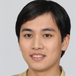 Joyful asian young-adult male with short  black hair and brown eyes