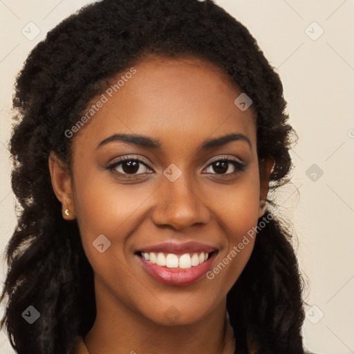 Joyful black young-adult female with long  brown hair and brown eyes