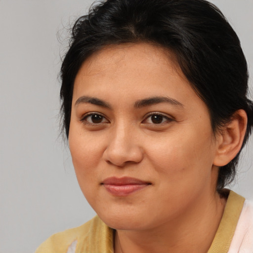 Joyful asian young-adult female with medium  brown hair and brown eyes
