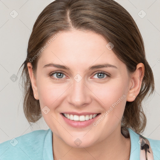 Joyful white young-adult female with medium  brown hair and blue eyes