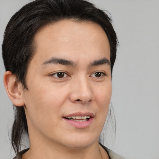 Joyful white young-adult male with medium  brown hair and brown eyes