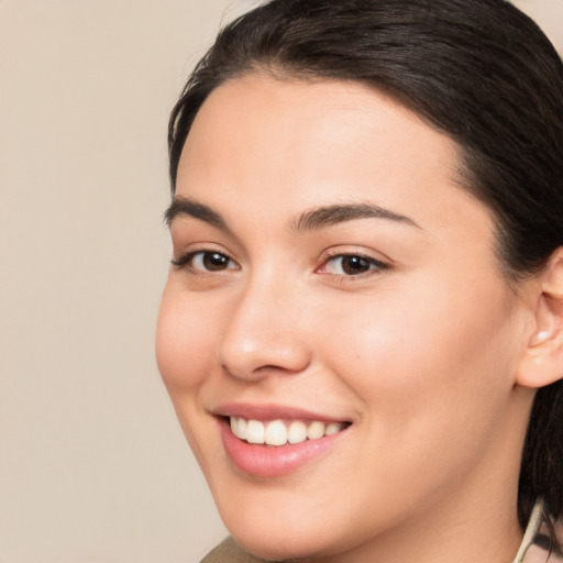 Joyful white young-adult female with medium  brown hair and brown eyes