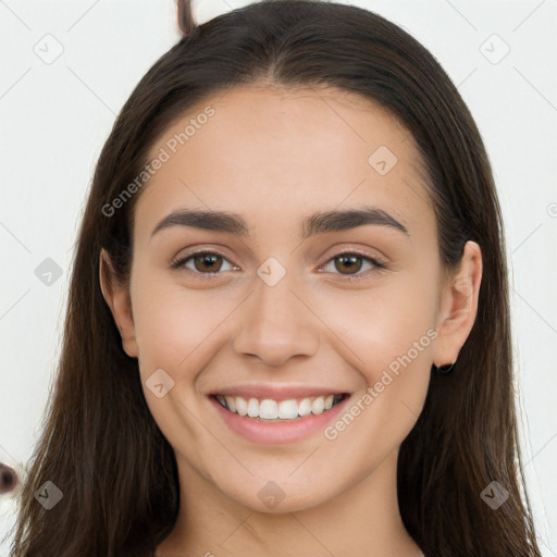 Joyful white young-adult female with long  brown hair and brown eyes