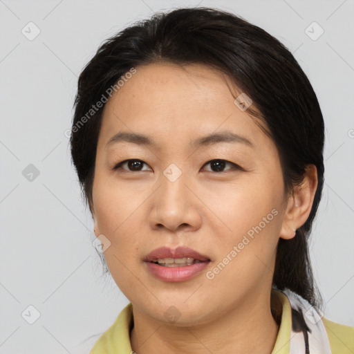 Joyful asian adult female with medium  brown hair and brown eyes