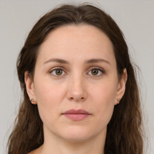 Joyful white young-adult female with long  brown hair and grey eyes