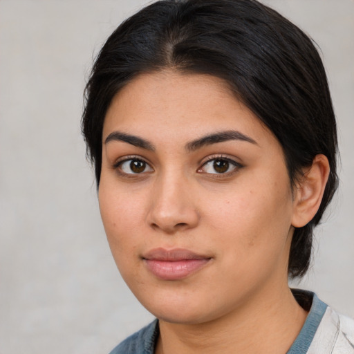 Joyful latino young-adult female with medium  brown hair and brown eyes