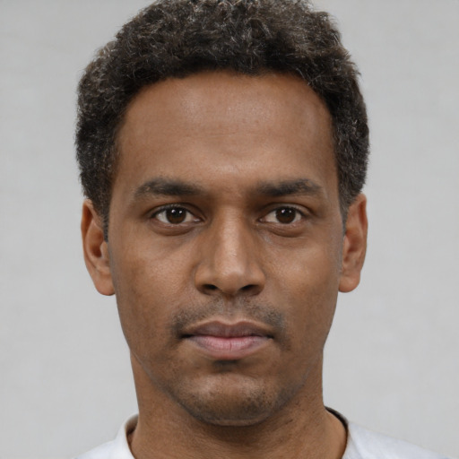 Neutral latino young-adult male with short  brown hair and brown eyes