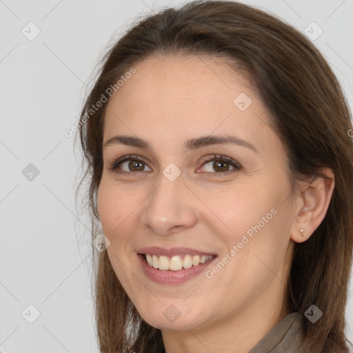 Joyful white young-adult female with long  brown hair and brown eyes