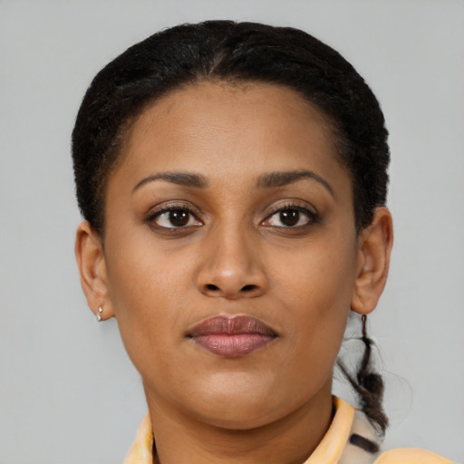 Joyful black young-adult female with short  brown hair and brown eyes