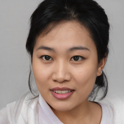 Joyful asian young-adult female with medium  brown hair and brown eyes