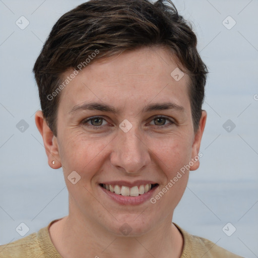 Joyful white young-adult female with short  brown hair and grey eyes