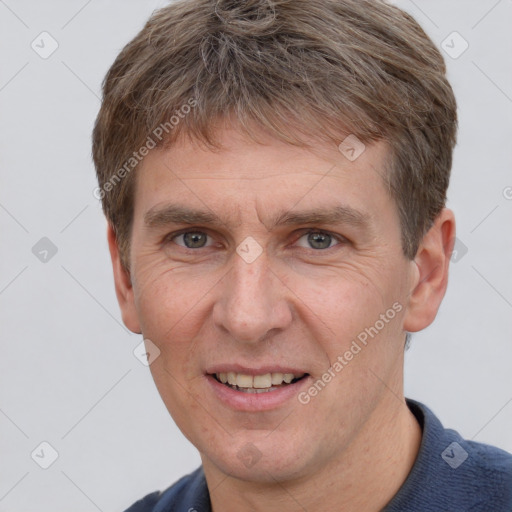 Joyful white adult male with short  brown hair and grey eyes