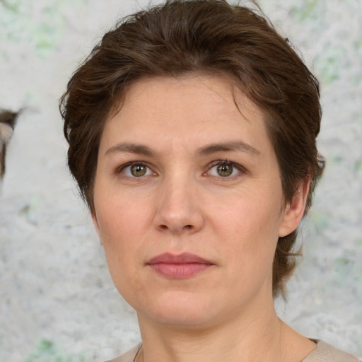 Joyful white young-adult female with short  brown hair and green eyes