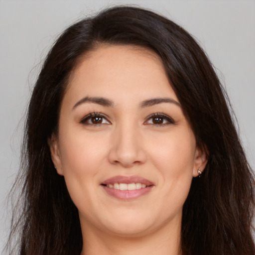 Joyful white young-adult female with long  brown hair and brown eyes