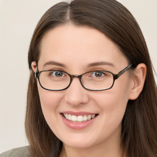 Joyful white young-adult female with long  brown hair and brown eyes