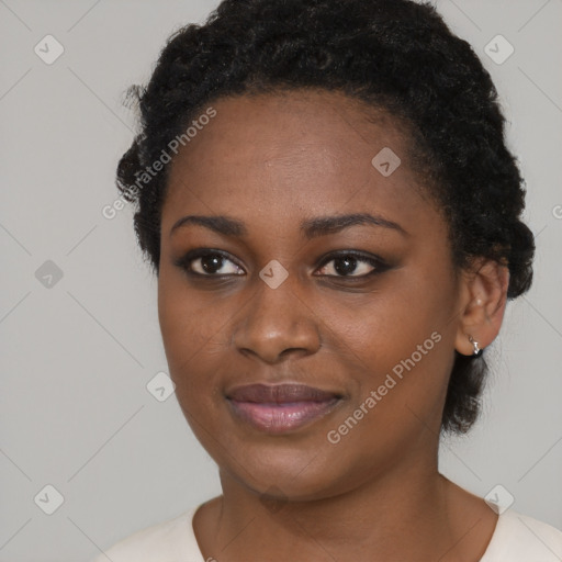 Joyful black young-adult female with short  black hair and brown eyes