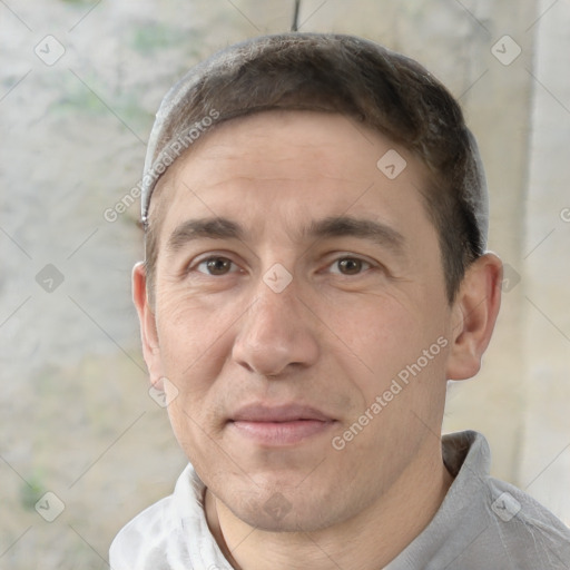 Joyful white adult male with short  black hair and brown eyes