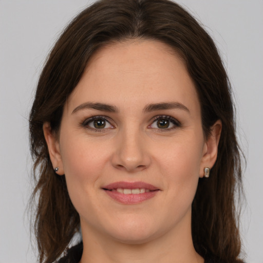 Joyful white young-adult female with medium  brown hair and green eyes