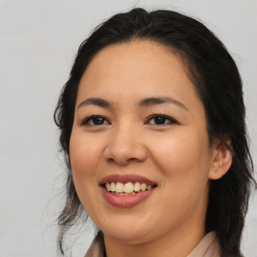 Joyful asian young-adult female with long  brown hair and brown eyes