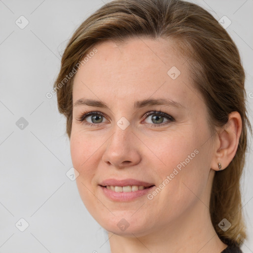 Joyful white adult female with medium  brown hair and grey eyes