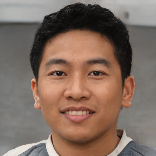 Joyful asian young-adult male with short  black hair and brown eyes