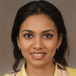 Joyful black young-adult female with medium  brown hair and brown eyes