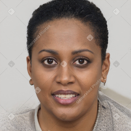 Joyful black young-adult female with short  brown hair and brown eyes