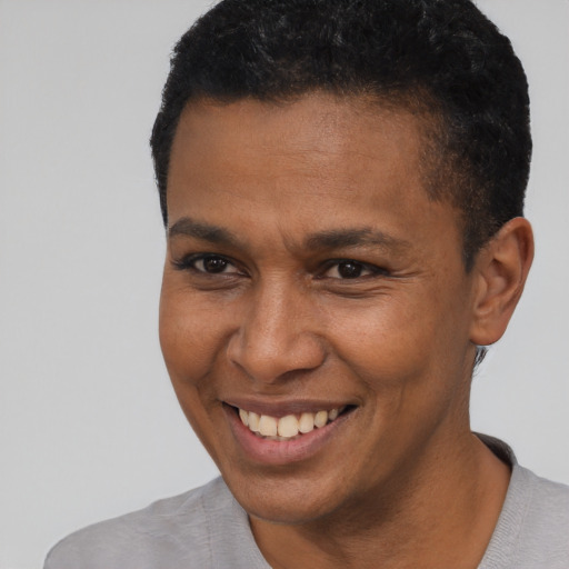Joyful black young-adult male with short  black hair and brown eyes