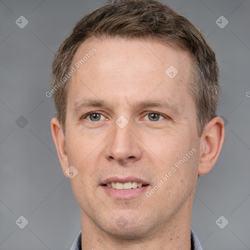 Joyful white adult male with short  brown hair and grey eyes