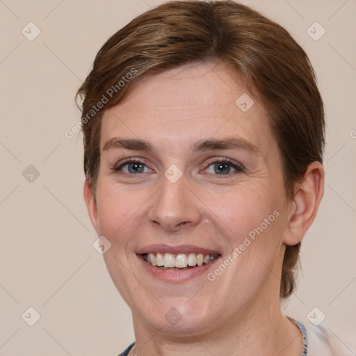 Joyful white adult female with medium  brown hair and grey eyes