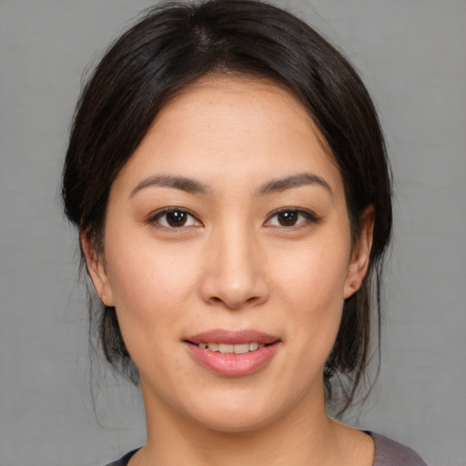 Joyful asian young-adult female with medium  brown hair and brown eyes