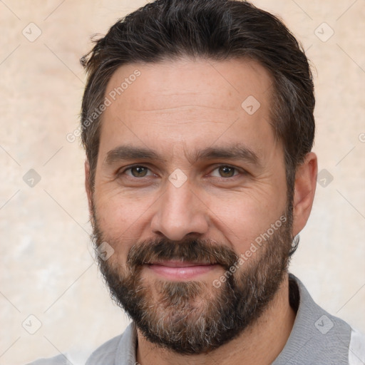 Joyful white adult male with short  black hair and brown eyes