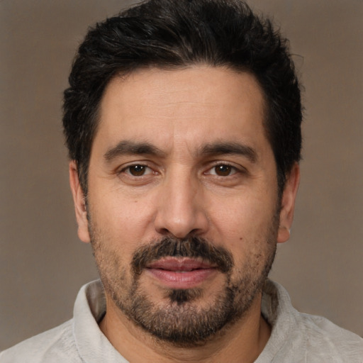 Joyful white adult male with short  black hair and brown eyes