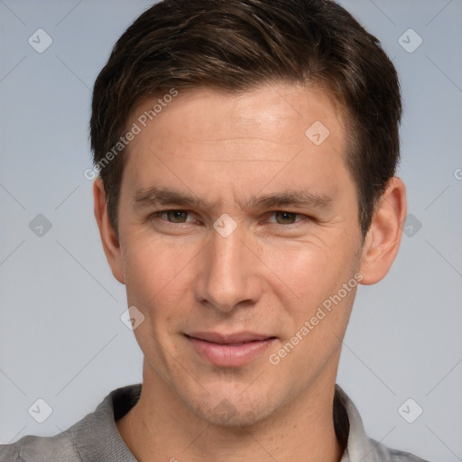 Joyful white adult male with short  brown hair and brown eyes