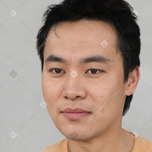 Joyful asian young-adult male with short  black hair and brown eyes