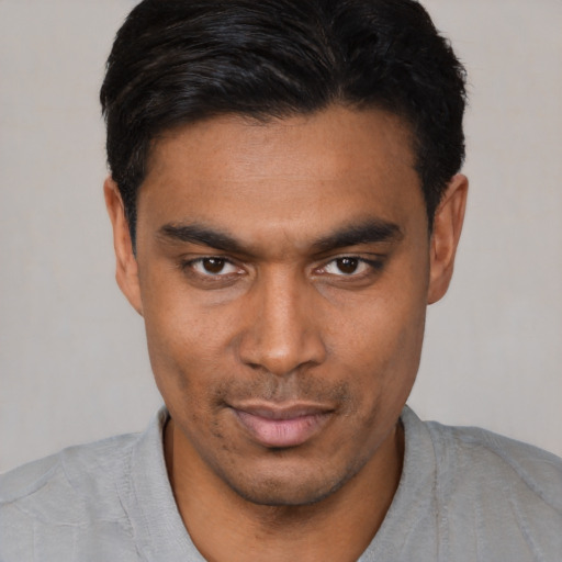 Joyful asian young-adult male with short  black hair and brown eyes