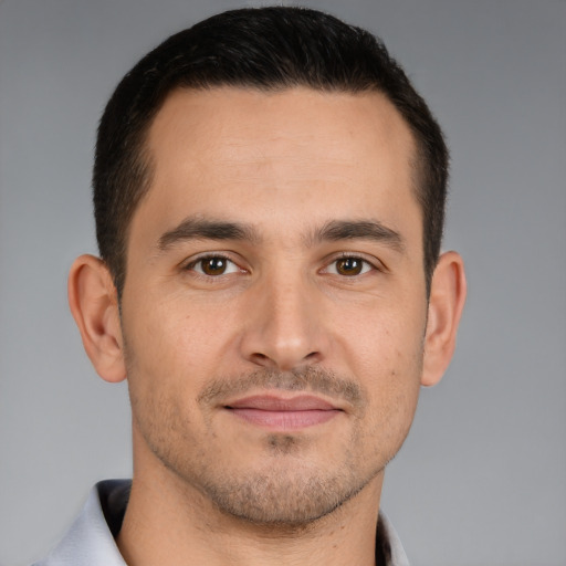 Joyful white young-adult male with short  brown hair and brown eyes